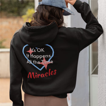 Gildan unisex zip-up hoodie with “Miracles Happen” design and uplifting message, Christian apparel made from soft cotton-poly fleece, ideal for cooler weather and faith-inspired comfort, woman wearing black hoodie